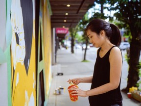 Jocelyn Wong working on a mural on a South Granville store during the COVID-19 lockdown. The mural was chosen for a Jones Soda Messages of Hope campaign. Photo: Gian-Paolo Mendoza