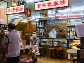 Workers at the traditional Chinese medicine shop wear face masks as a precaution against the spread of Coronavirus during a coronavirus (COVID-19) outbreak on March 26, 2020 in Hong Kong, China.