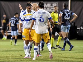 Chris Wondolowski #8 of San Jose Earthquakes and Shea Salinas #6 celebrate after defeating Vancouver Whitecaps by a score of 4-3 in the MLS is Back Tournament at ESPN Wide World of Sports Complex on July 15, 2020 in Reunion, Florida.