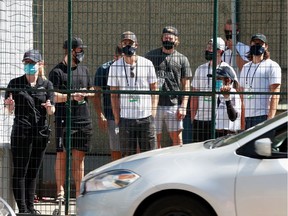 The Vancouver Canucks, who are in Edmonton for the NHL post-season, navigate protective fencing on their way to practise at Rogers Place in the Alberta capital.