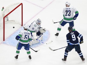 Jacob Markstrom allows a second period goal to Dmitry Kulikov of the Winnipeg Jets (not pictured).
