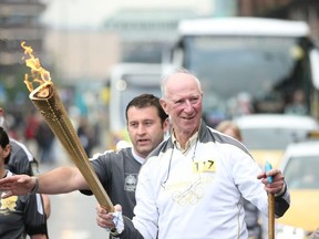 In this handout image provided by LOCOG, Torchbearer 117 Jack Charlton carries the Olympic torch on June 15, 2012 in Newcastle upon Tyne, England.