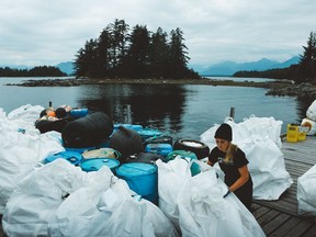 Lilly Woodbury, a spokesperson for the Surfrider Foundation Canada, works to clean up plastic garbage in the ocean. The foundation and other environmental groups are worried the pandemic has caused a huge setback in getting rid of single-use plastics.