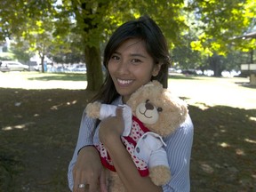 Mara Soriano stands in Alexandra Park in Vancouver on July 29, 2020, with Mama Bear, the Build-A-Bear that was stolen from her during a move last week and returned on Tuesday. The bear was given to Soriano by her mother the night before she died, and contains a recorded message from her mother that plays when you squeeze the bear's paw. Credit: Mike Bell/PNG [PNG Merlin Archive]