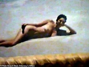 A woman alleged to be Ghislaine Maxwell stretches out in the sand at Jeffrey Epstein's Florida mansion. PALM BEACH STATES ATTORNEY