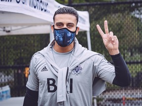 Vancouver Whitecaps left back Ali Adnan gives his sign of approval after arriving for training at the team's UBC practice facility in May.