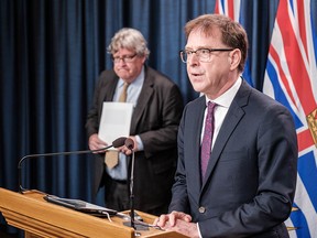 Health Minister Adrian Dix and Michael Marchbank, consultant to the Ministry of Health (in background), reveal early data from the initial weeks of B.C.’s Surgical Renewal Commitment.