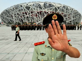 Chinese police patrol outside the Olympic Stadium in Beijing on July 21, 2008. Canada seems perfectly prepared to send its athletes to a sporting competition in a country where two of its citizens are held in state custody.
