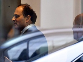David Sidoo, of Vancouver, enters an adjacent building with his lawyer following a federal court hearing Friday, March 15, 2019, in Boston. Sidoo faced charges of conspiracy to commit mail and wire fraud as part of a wide-ranging college admissions bribery scandal.