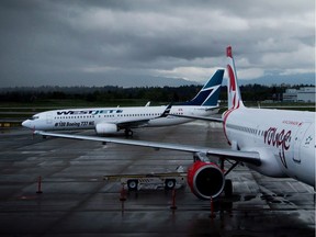 CP-Web. A Westjet Boeing 737-800, left, taxis past an Air Canada Rouge Airbus A319 at Vancouver International Airport in Richmond, B.C., on Monday, April 28, 2014. A new poll suggests turbulence ahead when it comes to the airlines winning public support for their current COVID-19 plans.