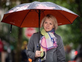 B.C. provincial health officer Dr. Bonnie Henry arrives to view the Murals of Gratitude exhibition in Vancouver, on Friday. The business improvement association in Vancouver's Gastown neighbourhood honoured Dr. Henry on Friday with a sneak peek at a mural exhibition featuring her image.