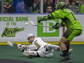 Saskatchewan Rush defender Jeff Cornwall pressures a downed Vancouver Warriors forward Keegan Bal in NLL action at SaskTel Centre in Saskatoon, Sask. on March 7, 2020.