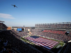 A file photo of Gillette Stadium, home of the New England Patriots, during an air force flyover. Packed stadiums won't be happening if and when play begins in 2020.