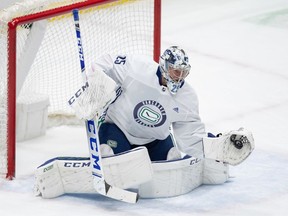 Vancouver Canucks goalie Jacob Markstrom, of Sweden, makes a glove save during a scrimmage during the NHL hockey team's training camp in Vancouver.