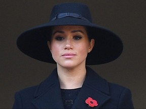 In this file photo taken Nov. 10, 2019, Britain's Meghan, Duchess of Sussex, looks on from a balcony as she attends the Remembrance Sunday ceremony at the Cenotaph on Whitehall in central London.