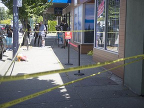 Police tape blocks off the front of 6416 Main Street (THC Canada) and 6418 Main (Dank Mart) on Tuesday after a fatal shooting.
