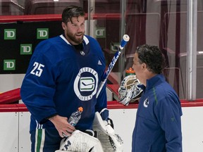 Jacob Markstrom and coach Travis Green share a laugh Monday at Rogers Arena.