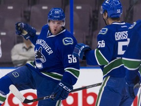 Michael Carcone, left, celebrates with Vancouver Canucks teammate Guillaume Brisebois after scoring a goal against the Edmonton Oilers during the 2017 Young Stars Classic held at the South Okanagan Events Centre in Penticton.