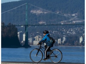A cyclist makes his way around Brockton Point while cycling in Stanley Park.
