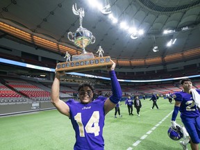 Vancouver College Fighting Irish Jason Soriano lifts the championship trophy after defeating the Lord Tweedsmuir Panthers to win the triple-A B.C. High School Football Championship at B.C. Place Stadium in Vancouver on Nov. 30, 2019. Nobody knows when another provincial championship can be held due to COVID-19.