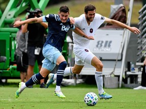 Vancouver Whitecaps defender Jake Nerwinski (28) and Chicago Fire forward Elliot Collier (28) chase a loose ball during the second half at the MLS is Back tournament in Florida.