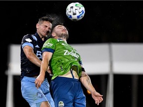 Vancouver Whitecaps defender Jake Nerwinski (28) and Seattle Sounders forward Jordan Morris (13) fight for a header during the first half at ESPN Wide World of Sports in July.