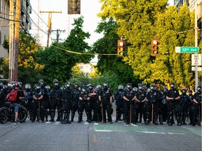File photo: Police block a road during protests near the Seattle Police East Precinct on July 26, 2020 in Seattle, Washington. Peaceful protests for racial justice took place following reports that federal agents may have been sent to the city.
