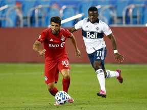 Cristian Dájome, right, and the Vancouver Whitecaps won't have to worry about facing 2020 MLS MVP Alejandro Pozuelo when they travel to Orlando for Saturday's game against Toronto FC. Pozuelo is yet to feature in a game this season because of injury.