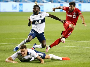 Toronto FC’s Alejandro Pozuelo shoots the ball as Cristian Dájome of Whitecaps FC defends during their game last week. TFC was dominant in the 3-0 win.