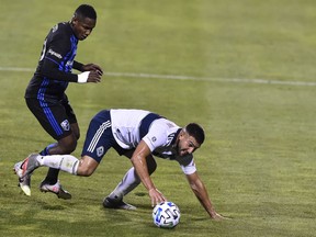 Lucas Cavallini and his Vancouver Whitecaps stumbled Tuesday night in Major League Soccer action at Saputo Stadium in Montreal. The host Impact, with some fans in the stands, scored twice in the first half and then cruised to victory. Romell Quioto of the Impact, left, scored the game's opening goal in the 18th minute.