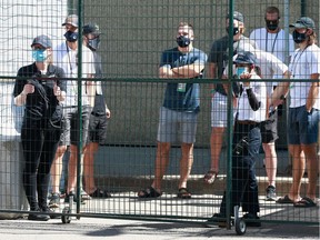 The Vancouver Canucks navigate protective fencing on their way to practice at Rogers Place on July 28 in Edmonton.
