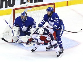 Morgan Rielly and Frederik Andersen of the Toronto Maple Leafs defend the net from Cam Atkinson of the Columbus Blue Jackets in the second period Game One of the Eastern Conference Qualification Round prior to the 2020 NHL Stanley Cup Playoffs at Scotiabank Arena on August 02, 2020 in Toronto, Ontario, Canada.