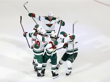 Kevin Fiala #22 of the Minnesota Wild celebrates with his teammates after scoring a goal in the first period in Game One of the Western Conference Qualification Round prior to the 2020 NHL Stanley Cup Playoffs at Rogers Place on August 02, 2020 in Edmonton, Alberta, Canada.