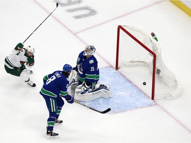 Jacob Markstrom #25 of the Vancouver Canucks tries to defend a goal by Kevin Fiala #22 of the Minnesota Wild in Game One of the Western Conference Qualification Round prior to the 2020 NHL Stanley Cup Playoffs at Rogers Place on August 02, 2020 in Edmonton, Alberta, Canada.