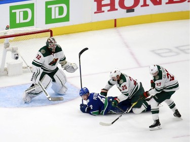 Elias Pettersson #40 of the Vancouver Canucks battles with Jonas Brodin #25 of the Minnesota Wild as Alex Stalock #32 of the Minnesota Wild defends the net in Game One of the Western Conference Qualification Round prior to the 2020 NHL Stanley Cup Playoffs at Rogers Place on August 02, 2020 in Edmonton, Alberta, Canada.