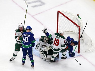 Troy Stecher #51 of the Vancouver Canucks and Luke Kunin #19 of the Minnesota Wild collide in Game One of the Western Conference Qualification Round prior to the 2020 NHL Stanley Cup Playoffs at Rogers Place on August 02, 2020 in Edmonton, Alberta, Canada.