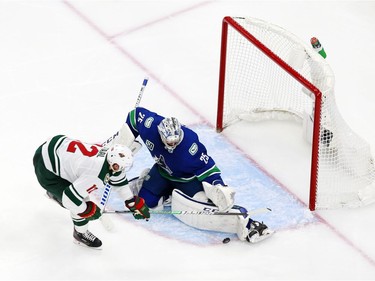 Eric Staal #12 of the Minnesota Wild takes a shot on goal as Jacob Markstrom #25 of the Vancouver Canucks defends  in Game One of the Western Conference Qualification Round prior to the 2020 NHL Stanley Cup Playoffs at Rogers Place on August 02, 2020 in Edmonton, Alberta, Canada.