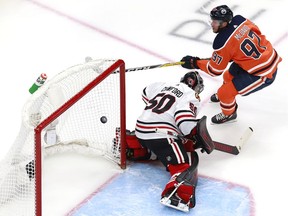 Connor McDavid of the Oilers scores his second goal against Corey Crawford of the Chicago Blackhawks during the first period in Game 2 of the Western Conference qualification round before the Stanley Cup playoffs, at Rogers Place on Aug. 3 in Edmonton.