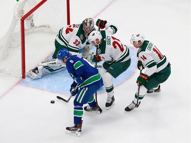 Alex Stalock #32 of the Minnesota Wild defends against Brock Boeser #6 of the Vancouver Canucks in Game 2.
