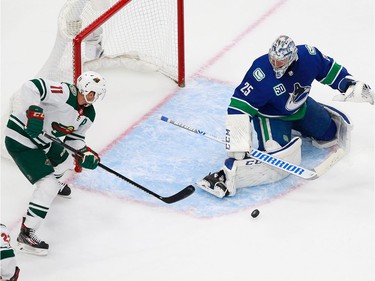 Jacob Markstrom #25 of the Vancouver Canucks makes a save against Zach Parise #11 of the Minnesota Wild in Game 2.