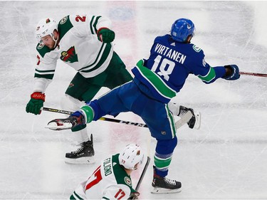 Jake Virtanen #18 of the Vancouver Canucks and Alex Galchenyuk #27 of the Minnesota Wild collide in Game 2.