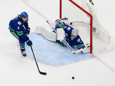 Jacob Markstrom #25 and Chris Tanev #8 defend the net in Game 2.