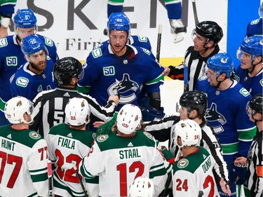 Jay Beagle #83 of the Vancouver Canucks exchanges words with Eric Staal #12 of the Minnesota Wild at the end of Game 2.