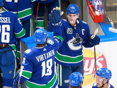 Bo Horvat #53 and Jake Virtanen #18 of the Vancouver Canucks celebrate their 4-3 victory in Game 2.