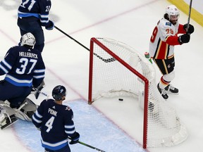 Dillon Dube of the Calgary Flames celebrates after scoring a goal on Connor Hellebuyck of the Winnipeg Jets during the first period in Game 4 of the Western Conference Qualification Round prior to the 2020 NHL Stanley Cup Playoffs at Rogers Place on August 06, 2020, in Edmonton.