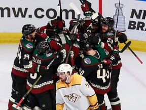 Brad Richardson of the Arizona Coyotes is mobbed by his teammates after scoring in overtime to defeat the Nashville Predators 4-3 in Game 4 of their NHL Western Conference qualifying series at Rogers Place in Edmonton on Aug. 7, 2020.