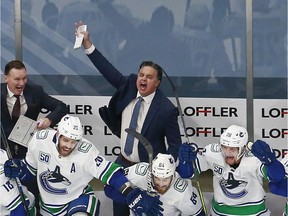 Head coach Travis Green of the Vancouver Canucks celebrates his teams 5-4 win on a goal by Christopher Tanev (not pictured) at :11 in overtime to defeat the Minnesota Wild in Game Four and the Western Conference Qualification Round prior to the 2020 NHL Stanley Cup Playoffs at Rogers Place on Aug. 7, 2020 in Edmonton, Alberta.
