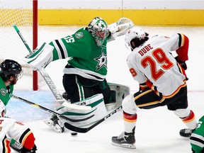 Dillon Dube #29 scores a first period goal on Anton Khudobin #35 of the Dallas Stars in Game One of the Western Conference First Round during the 2020 NHL Stanley Cup Playoffs at Rogers Place on August 11, 2020 in Edmonton, Alberta, Canada. The Flames defeated the Stars 3-2.