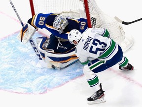 Jordan Binnington of the St. Louis Blues makes a first period stop on Bo Horvat of the Vancouver Canucks in Game One of the Western Conference First Round during the 2020 NHL Stanley Cup Playoffs at Rogers Place on Aug. 12, 2020 in Edmonton.