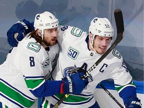 Captain Bo Horvat of the Vancouver Canucks celebrates his shorthanded goal on Friday in Edmonton with Chris Tanev. Horvat also scored in overtime as Vancouver grabbed a 2-0 series lead against the St. Louis Blues.